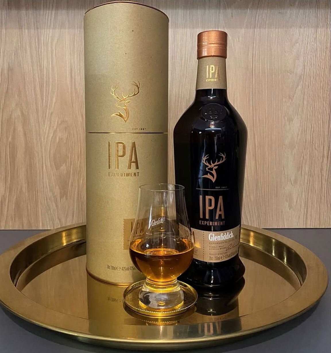 Bottle of Glenfiddich IPA whisky, cylindrical packaging, and glass with whisky on a gold tray. Glenfiddich IPA Experiment 700ml Price Philippines